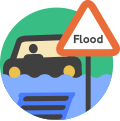 Road sign saying flood next to a car surrounded with water